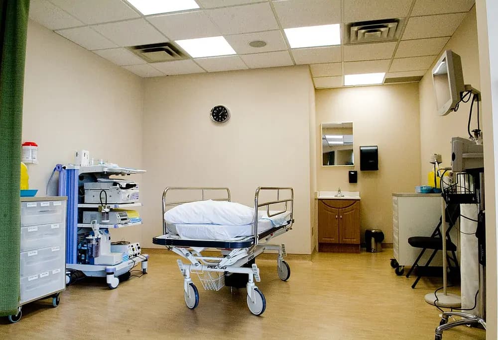 Photograph of an equipment tower, screen and examination bed in an endoscopy room